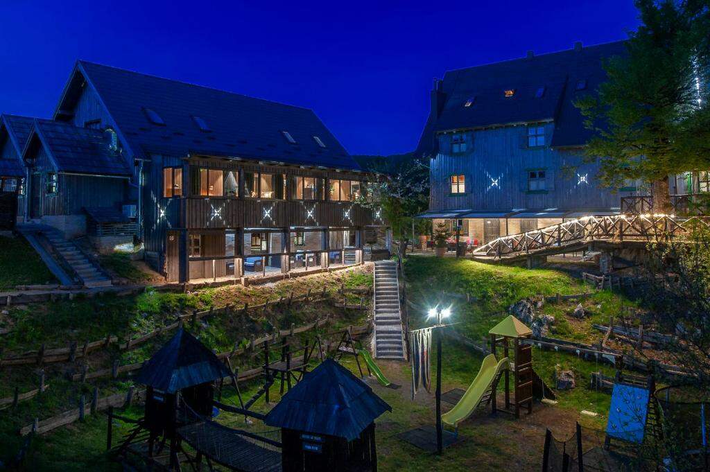 Hotel exterior at night with an illuminated playground